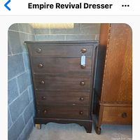 Front view of dark stained five-drawer dresser with round wooden pulls