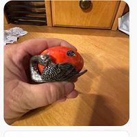 Front view showing red marble egg and silver-tone swan stand with sticker