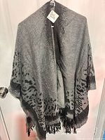 Front view of entire shawl draped showing pattern and fringe