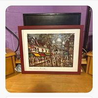 Front view of framed Jacques Chardon Montmartre print on table