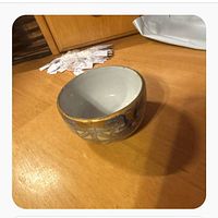 Side view of tea bowl showing gold and blue exterior design