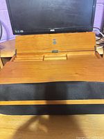 Front view showing wooden stand with black wrist rest