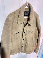 Front view of Levi's tan sherpa trucker jacket