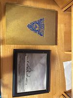 Book and framed photo on table