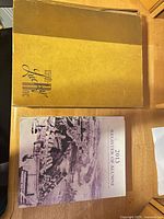 Front covers of 1948 Lucky Bag yearbook and 2013 Register of Alumni book