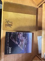 Lucky Bag 1948 yearbook and 2008 Alumni Register book on desk