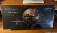 Front of sealed HiDow Foot Massager retail box showing product image and key benefits