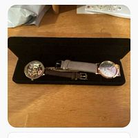 Two Olivia Burton watches in black case on table
