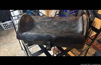 Closed wooden box showing leather lid and strap