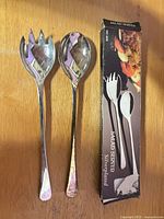 Salad serving fork and spoon beside original retail box