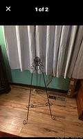 Full view of black metal scrollwork easel