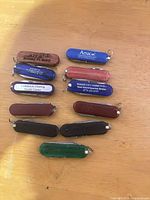 All eleven key-chain knives arranged on tabletop