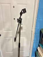 Full view of microphone stand leaning against door