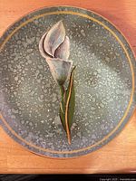 Front of plate showing Blue Tulips design, speckled glaze, gold rim