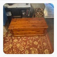 Front view of closed cedar chest on rug
