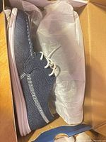 Top view of right shoe in box with tissue paper