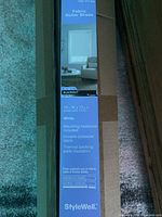 Label on sealed StyleWell roller shade tube showing size 73 in W x 72 in L, white, blackout, thermal backing