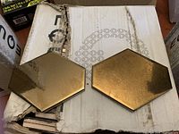 Two gold/bronze crackle hexagon tiles on box