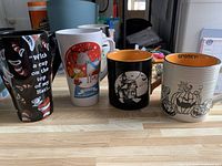 Front view of all four mugs lined on counter
