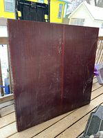 Closed cabinet showing dark wood exterior with scratches