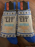 Front view of both pairs with Hot Sox branding and graphic design visible