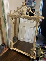 Full view of carved tropical mirror frame standing on floor