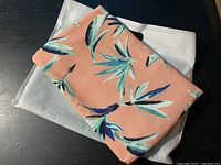 Floral side of clutch resting on dust bag