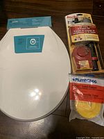 Overall view of toilet seat, fill valve & flapper kit, and separate flapper