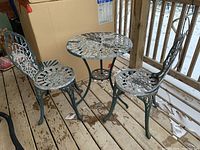 Full view of table and both chairs on deck