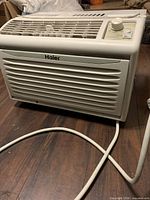 Front view showing grille, control knob and power cord