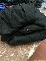 Folded view of all three black garments