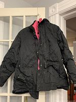 Full view black coat with pink liner showing