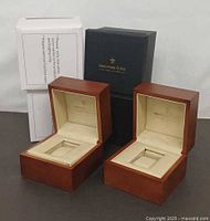 Two open wooden Dreyfuss & Co watch boxes with outer sleeves