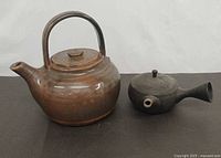 Front view of both teapots showing shapes and glaze