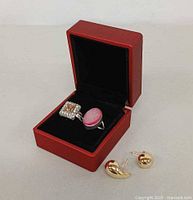 Rings in red box with earrings in front