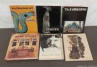 Front view all six books upright