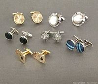 All six pairs of cufflinks arranged in rows
