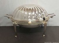 Front view showing full tureen with lid closed and legs