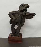 Front view of Frank Meisler fiddler sculpture showing full figure and wood base