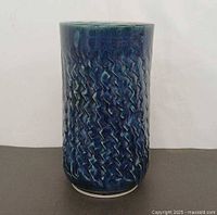 Front view of blue glazed vase showing zig-zag texture
