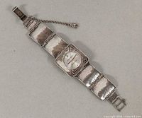 Front view of Silpada sterling silver watch showing hammered link bracelet, bezel, dial, safety chain