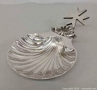 Top view showing shell bowl and cross finial