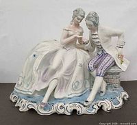 Front view showing entire figurine of courting couple on ornate base