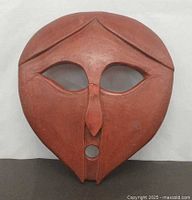 Front view of terracotta mask sculpture