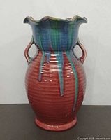 Front view of drip glaze pottery vase showing color pattern and handles