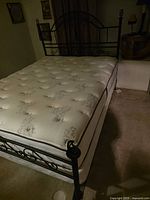 Full view of metal bed frame assembled with mattress on top