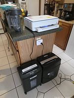 Overall view: HP printer on counter, two shredders below