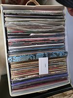 Top view of storage box filled with stacked 12" LP records in jackets and sleeves