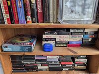 Shelves with VHS tapes, books, boxed item, signed Millie Jackson photo