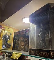 The Crow boxed figure and Phantom of the Opera carded figure on shelf